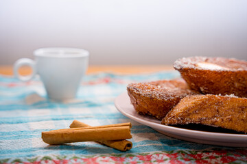 Traditional Spanish torrijas, dessert often enjoyed during Lent and Holy Week or Semana Santa, and Easter, similar to french toast, with cup or coffee or cappuccino, ready for breakfast