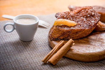 Traditional Spanish torrijas, dessert often enjoyed during Lent and Holy Week or Semana Santa, and Easter, similar to french toast, with cup or coffee or cappuccino, ready for breakfast