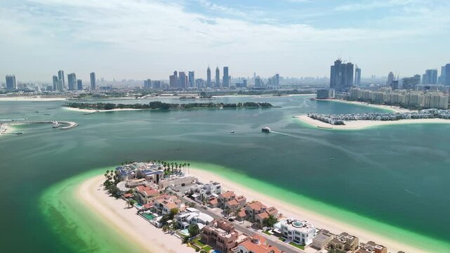 Dubai, UAE: Aerial view of capital city of Emirate of Dubai, artificial islands beach district of Palm Jumeirah - landscape panorama of Arabian Peninsula from above
