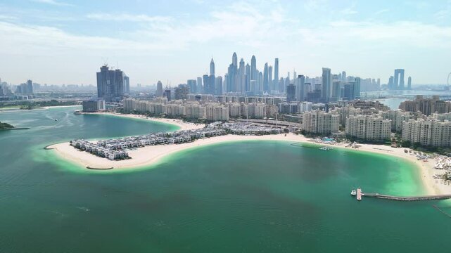Dubai, UAE: Aerial view of capital city of Emirate of Dubai, artificial islands beach district of Palm Jumeirah - landscape panorama of Arabian Peninsula from above
