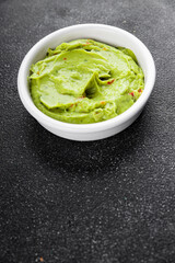 Guacamole dip avocado sauce cold appetizer vegetable dish organic product fresh tasty gourmet food background on the table rustic food top view copy space 