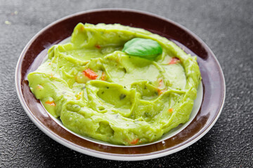 Guacamole dip avocado sauce cold appetizer vegetable dish organic product fresh tasty gourmet food background on the table rustic food top view copy space 
