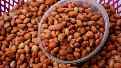 Uncooked peeled peanuts in wooden placemats  on desk
