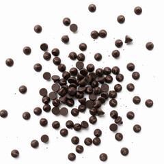 Chocolate chips on white background. Top view. Flat lay pattern.