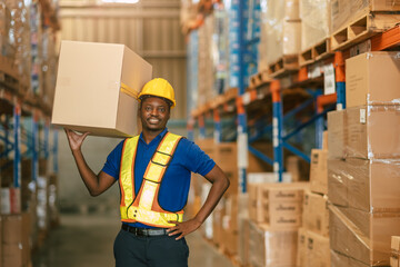 happy warehouse worker carrying lifting products container box for shipping in cargo industry