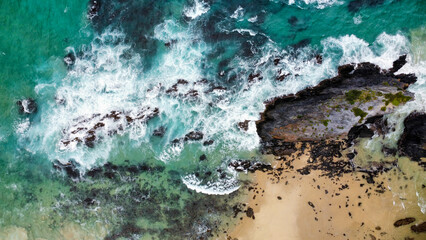 Rocks off the coast in rough seas, seen from above