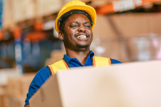 warehouse worker carrying lifting very heavy weight box moving storage box in cargo muscle back pain
