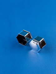Close-up of silver bolts for fastening car wheels on blue background