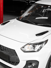 Close-up tuning, black decorative trim on white hood of sports car