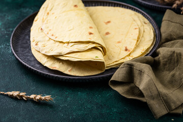 Lavash flat bread on green background
