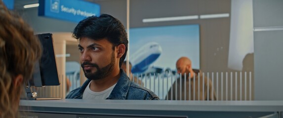 Airport Check-in Counter: Indian Man Giving Documents and Airplane Ticket to Airline Agent,...