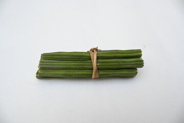 Moringa oleifera or drumstick pods on white background. This is a Moringaceae family tree. Its other names  moringa, horseradish, and ben oil tree and benzolive. It is a popular vegetable. 