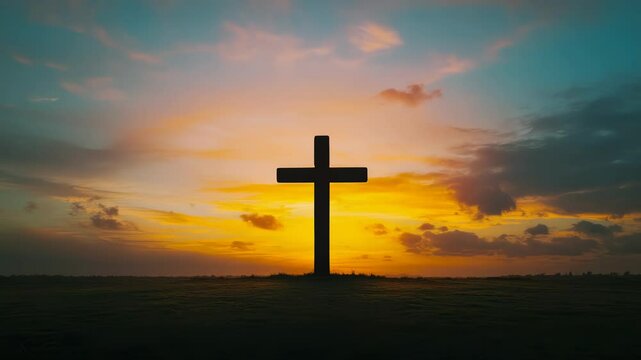 A cross is standing in a field at sunset. The sky is filled with clouds, and the sun is setting in the distance. The scene is peaceful and serene, with the cross serving as a symbol of hope and faith