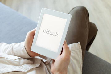Man reading ebook. Modern digital e-book tablet with electronic ink technology for relaxation, education and business.