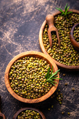 Raw uncooked mung beans on black background