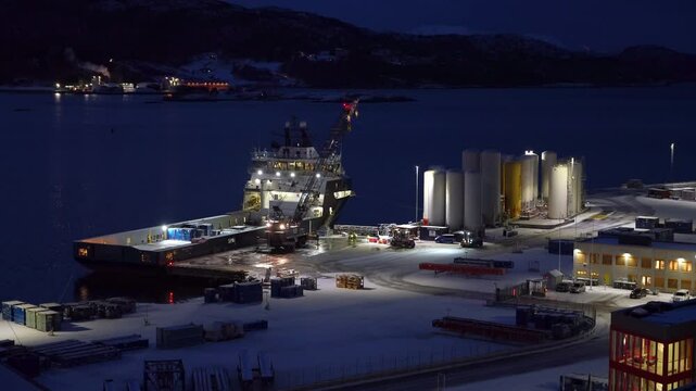 mobile crane unloads containers from the offshore supply vessel Troms Arcturus at Vestbase