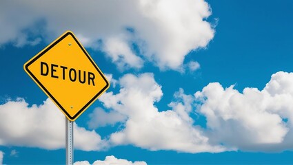 Bright yellow diamond-shaped road sign with bold black text detour concept of life redirection under blue sky