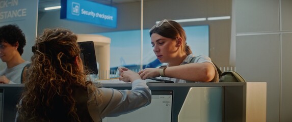Queue of Multiethnic Passengers at Airport Check-in Counter: Female Airline Worker Checking...