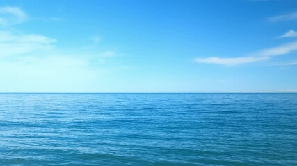 Nature blue background with wavy sea ripples on water surface and cloudy sunny sky. Scenery seascape horizon light. Wild ocean coastline, tourism, place for rest relax on vacation, journey, trip. - Powered by Adobe