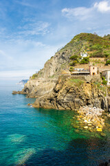 Obraz premium Crystal clear water on the coastline of Riomaggiore, Cinque Terre, Liguria, Italy