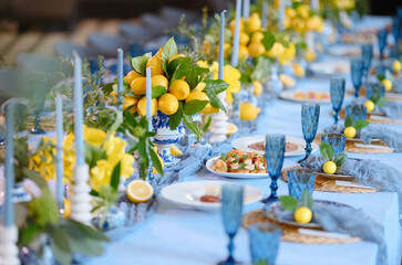Elegant Dining Table Decorated with Lemons and Blue Accents for Special Occasion
