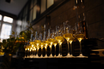Elegant Setup of Glasses with Golden Liquid in Sophisticated Venue
