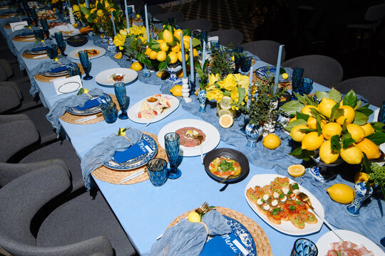 Elegant Dining Table Setting with Fresh Lemons and Colorful Dishes for a Culinary Celebration