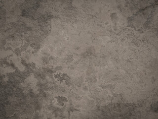 Rough gray cement texture with some darker spots, perfect for industrial backgrounds.