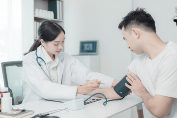 Health checkup concept in hospital. Professional female doctor in white coat examining male patient...