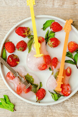 Frozen ice with strawberry,mint in guitar shape for cold fresh summer lemonade cocktail drinks. Homemade sweet fruit berry ice cream popsicles dessert food