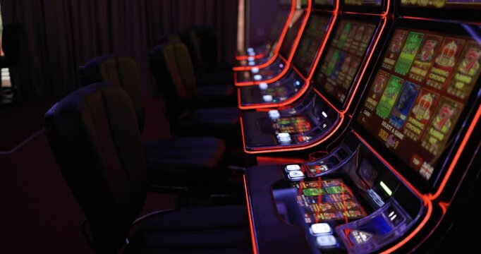 Empty Casino Slot Machines with Neon Lights, Ready for Gamblers