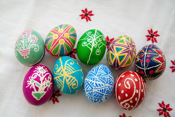 Painted eggs painted in the traditional way with a candle and paints against the background of a Ukrainian towel pattern