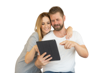 Young smiling couple looking together the tablet