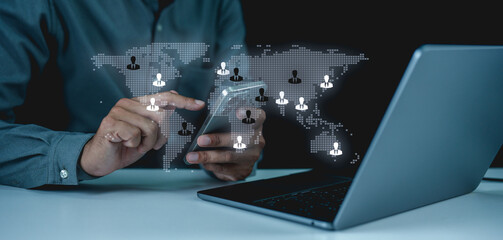 A businessman interacts with a smartphone, surrounded by a digital world map and icons representing global connectivity and communication.