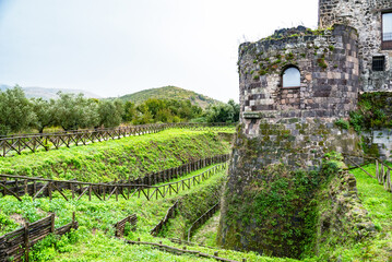 Old medieval Aragonese Castle surrounded by green fields in in Calvi Risorta, Caserta province.