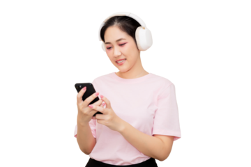 Asian young woman wearing headphones is smiling while using her smartphone, engaged in an enjoyable activity.