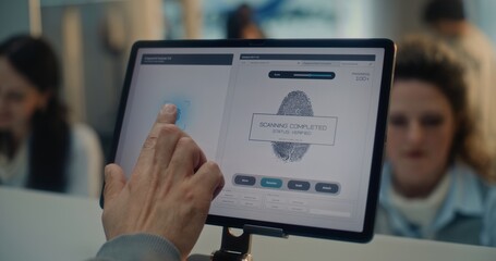 Airport Check-in Counter: Close Up of Man Putting Finger on Digital Tablet Touch Screen for...
