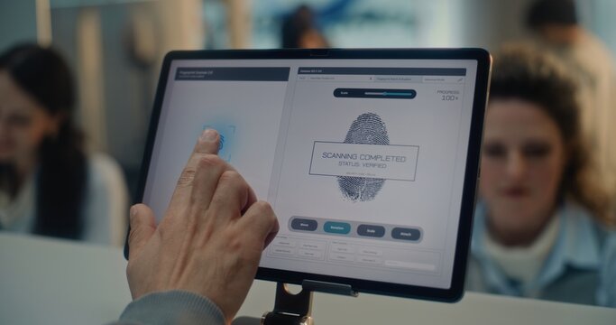Airport Check-in Counter: Close Up of Man Putting Finger on Digital Tablet Touch Screen for Fingerprint Scanning. Female Airline Agent Checking Passenger Biometric Data for Flight. Airport Terminal. - Powered by Adobe