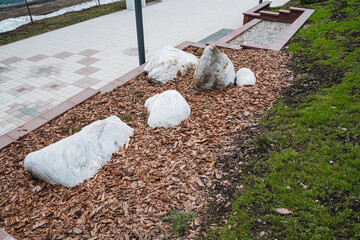 A beautiful natural landscape featuring decorative white rocks and wood mulch enhances the park...