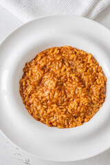 Creamy tomato risotto on clean white plate