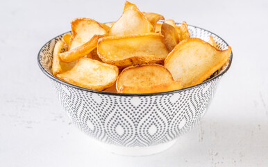 Golden potato dippers served hot in bowl, crispy edges and rustic feel