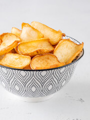 Golden potato dippers served hot in bowl, crispy edges and rustic feel