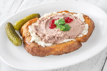 Gourmet sandwich layered with pate, cranberry jam, and cream cheese