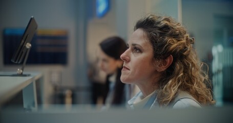 Airport Check-in Counter: Close Up of Female Airline Workers Accepting and Checking Documents and...