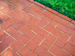 A fragment of a sidewalk made of red construction bricks