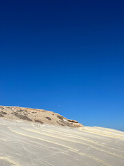 The rocky coast of the Mediterranean sea. Blue sea and high cliffs. Seascape. Holidays in Cyprus