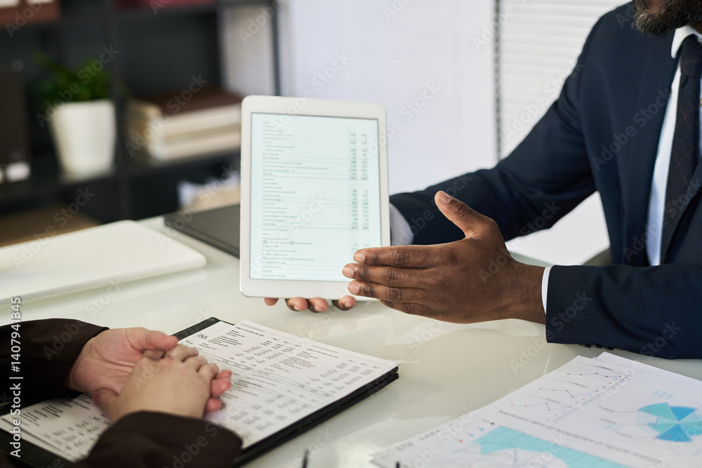 Aufkleber close-up of businessman discussing financial report on tablet pc with his colleague at table