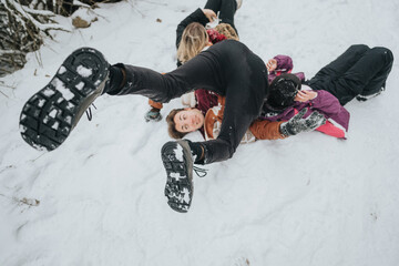 A group of friends enjoying a playful moment in the snow-covered outdoors, combining nature and...