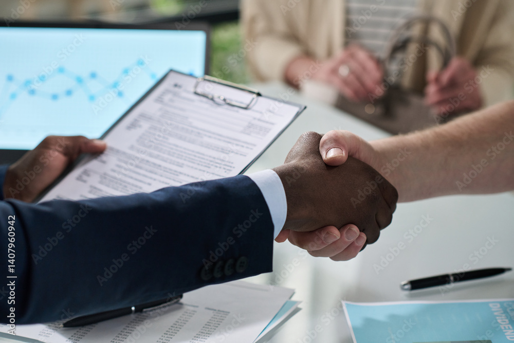 Poster close-up of manager shaking hands with customer to conclude a deal at meeting