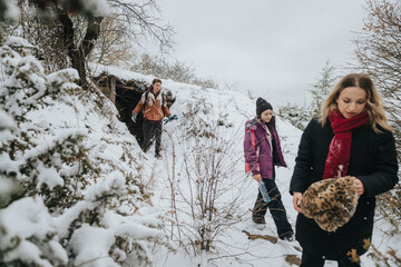 Three friends engage in a winter exploration, trekking through a snow-covered landscape, showcasing camaraderie and nature's beauty in a cold, frosty environment.